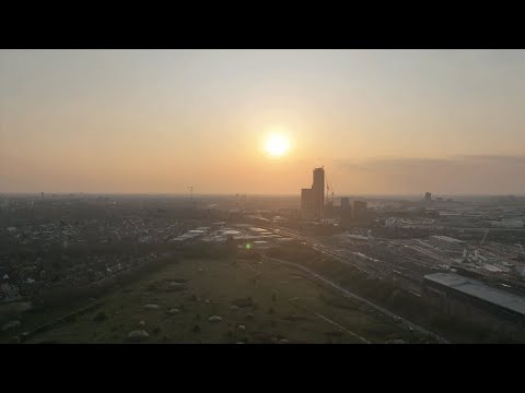 The sun sets across London's city line (Drone Footage)