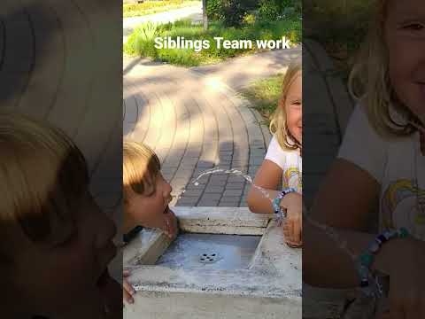 Sister helps little brother to drink water 💦 from street tap